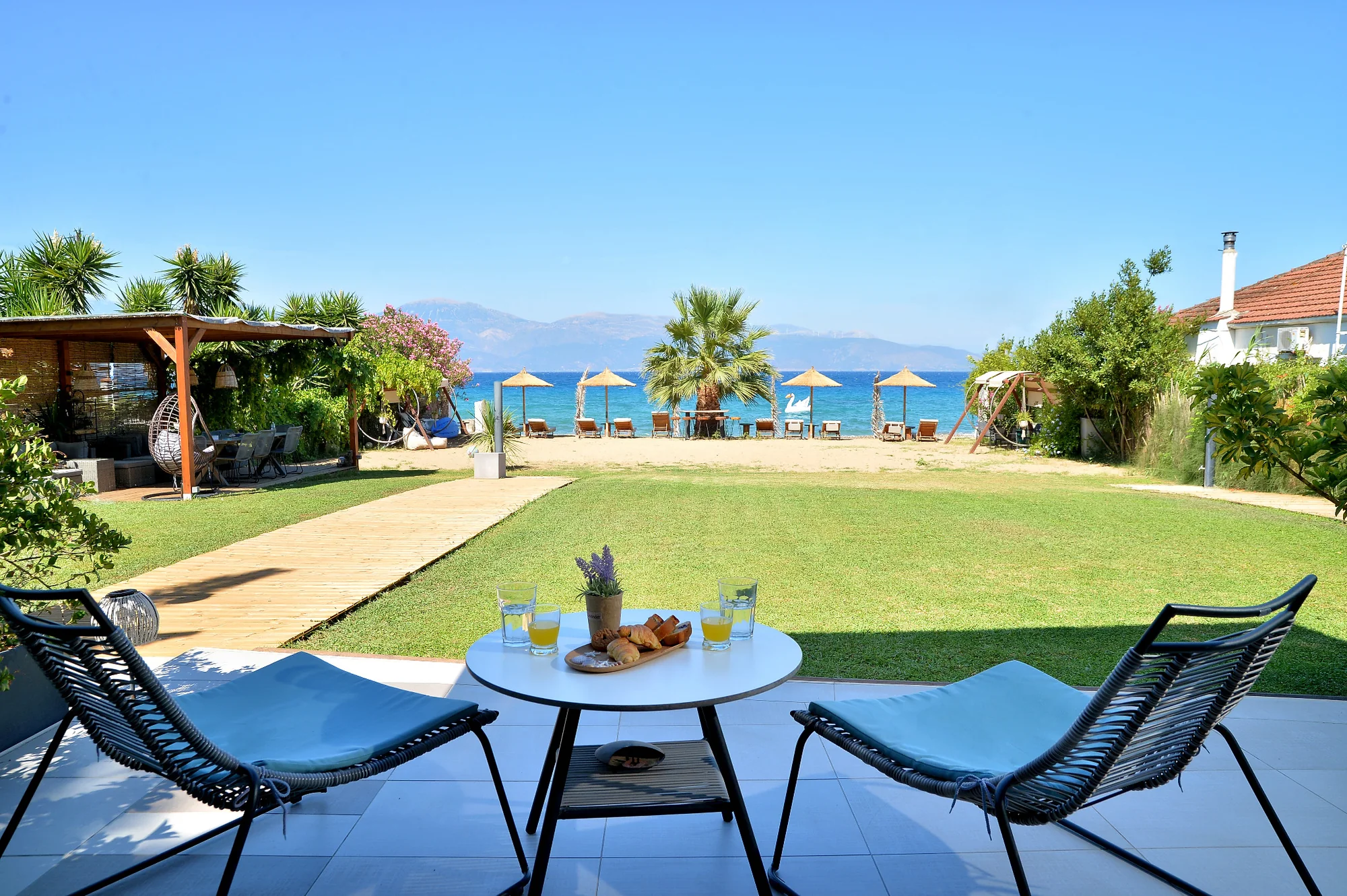 Terrace, garden and beach at Seacret Apartments