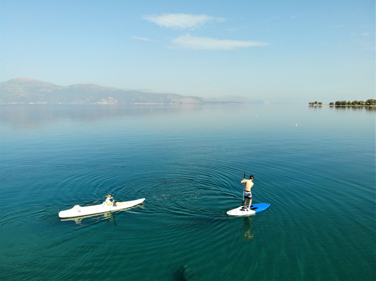 SUP and canoe on calm sea water